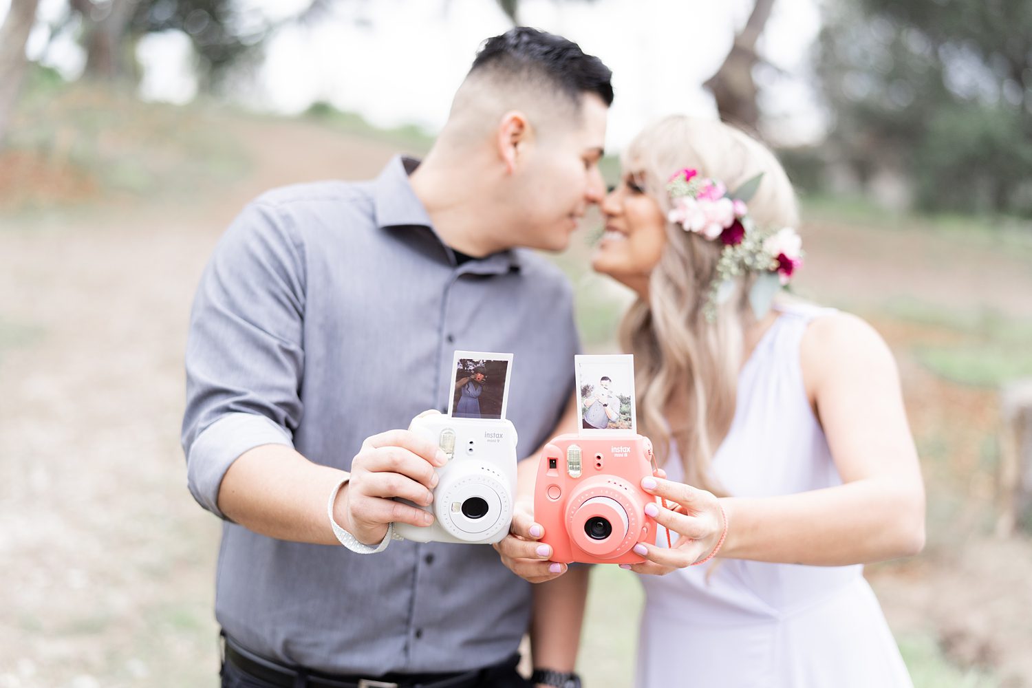 engaged couple in the woods taking selfies